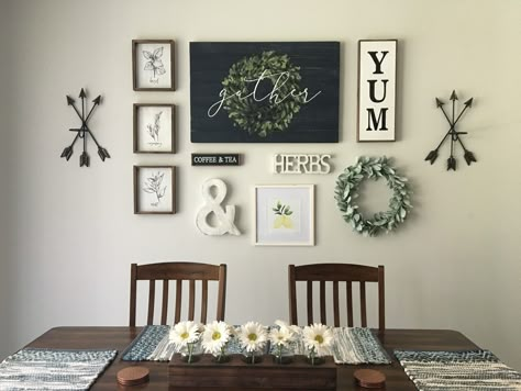 2 Arrow Sconces, 3 Herb Signs, Black Coffee & Tea Sign, Whitewashed Ampersand, Whitewashed Herbs Cutout, Framed Lemons Watercolor, Dark Blue Gather Sign (wall centerpiece), Yum Sign, Lamb’s Ear Wreath. All items purchased from Hobby Lobby🙌🏻 Used craft paper and painters tape to set layout and then hang. Super easy! Ampersand Decor Ideas, Diy Eat Sign, Dining Room Decor For Walls, Kitchen Dinning Room Wall Decor, Kitchen Wall Decor Ideas Above Table, Dining Room Decor Grey Walls, Living Room Wall Decor Hobby Lobby, Black Kitchen Wall Decor, Dining Room Collage Wall Ideas