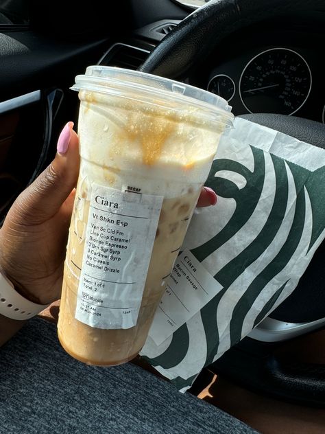 A Venti Iced Shaken Espresso from Starbucks with customized syrups and caramel drizzle, held in a hand with a pink manicure, with a Starbucks sandwich bag in the background. Starbucks Shaken Espresso, Iced Shaken Espresso, Iced Coffee Espresso, Blonde Espresso, Vanilla Sweet Cream, Javy Coffee, Coffee Orders, Shaken Espresso, Best Iced Coffee