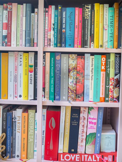 pink bookcase packed with cookbooks with various colourful spines Pretty Cookbooks To Display, Cookbook Bookshelf, Book Hoarding, Pink Bookcase, Cookbook Display, Kitchen Books, Rosemary Roasted Chicken, House Organization Ideas, Middle Eastern Sweets