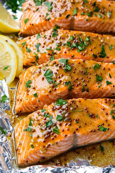 Try this delicious recipe for Honey Mustard Baked Salmon tonight! This easy-to-make dish is bursting with flavor and is perfect for a quick weeknight dinner or special occasion. The combination of sweet honey and tangy mustard creates a mouthwatering glaze that perfectly complements the tender salmon fillets. Simply mix together the honey, mustard, and some herbs, brush over the salmon, then bake until golden brown and cooked through. Whole Grain Mustard Salmon, Salmon Mustard Recipes, Salmon Recipes With Honey, Mustard Salmon Recipes, Dijon Mustard Salmon, Honey Dijon Salmon, Honey Butter Salmon, Mustard Glazed Salmon, Salmon With Mustard