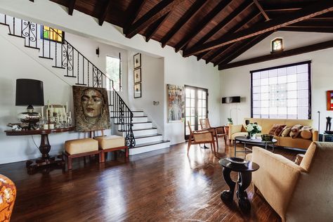 A Cozy Spanish-Style on Hollywood Boulevard Seeks $2.8M - Dwell Spanish Revival Interior, Modern Spanish Revival, Red Brick Fireplaces, Spanish Revival Home, High Ceiling Living Room, 1920s House, Los Angeles Real Estate, Warm Interior, Spanish Style Home