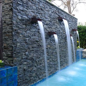 Custom Pool Water Features | Waterfalls, Gushers, Jets | Platinum Pools Swimming Pool Waterfall, Outdoor Wall Fountains, Water Fountain Design, Water Feature Wall, Swimming Pool Architecture, Outdoor Water Features, Pool Water Features, Pool Fountain, Backyard Water Feature