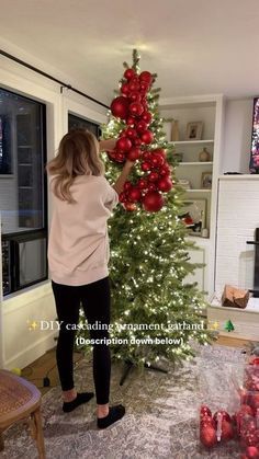 Christmas Tree Cluster Ideas, Red Beads On Christmas Tree, Red Ornament Garland On Tree, Spiral Ornament Tree, Big Ornaments On Tree Decorating Ideas, Christmas Tree Ideas Big Ornaments, Ornament Garland On Christmas Tree, Garland In Christmas Tree, Christmas Ornaments Garland On Tree