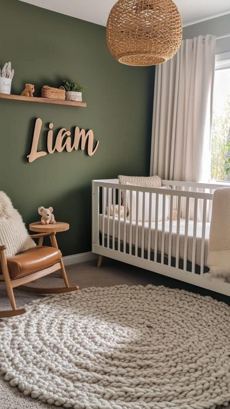 Modern earthy baby boy nursery with deep green walls, a personalized wooden name sign, and cozy textures. Hunter Green Nursery Gender Neutral, Nursery Light Green Walls, Forest Green Accent Wall Nursery, Sage Green Jungle Nursery, Nursery With Green Crib, Grey And Sage Nursery, Dark Green Girl Nursery, Baby Nursery Sage Green, Boy Nursery Green Accent Wall