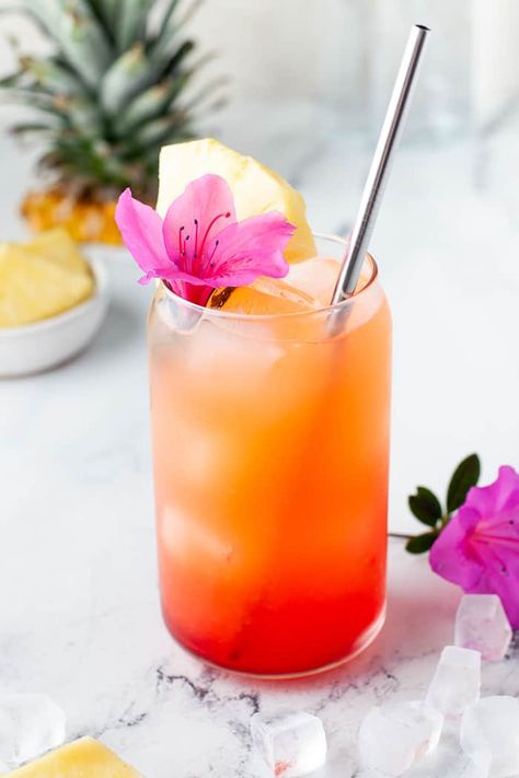 My go-to drink for this spring and summer is this Pineapple Orange Rum Punch. Transcend yourself to the tropical islands even when sipping on this drink in your kitchen. Tropical Fruit Cocktail, Tropical Cocktail Aesthetic, Orange Themed Cocktails, Pink And Orange Drink, Pineapple Summer Drinks, Tropical Food For Party, End Of Summer Cocktails, Easy Tropical Cocktails, Refreshing Cocktail Recipes