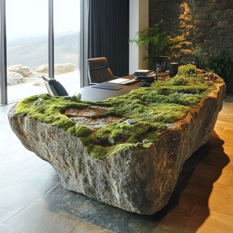 This moss-covered rock office desk blends natural beauty with functional design. The surface is made from a smooth, polished stone, carefully selected for its organic texture, and adorned with a live moss layer that creates a serene, earthy ambiance. The moss adds a soft, tactile contrast to the rock’s solid structure, evoking a tranquil forest floor. Perfect for those who want to bring the outdoors into their workspace, this desk is not only a statement piece but also a reminder of nature’s ... Rock Table Design, Terrarium With Water, Green Business Ideas, Organic Office, Rock Furniture, Moss House, Stone Desk, Moss Table, Stone Counter