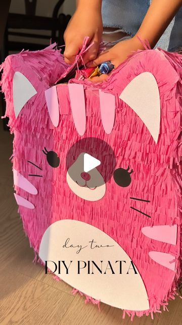 jennjoyceee on September 2, 2023: "No Squishmallow piñata available in stores? No problem! A little upcycle of cardboard boxes, some masking tape, streamers, and glue and voila! Here’s what we did ⬇️ 1. This is my first time making a piñata, so I stuck to an easy design and a single colour. 🪅💕 2. I made a stencil and cut the front and back of the piñata using a shipping box 📦 3. I used cereal boxes to cut out 3” strips for the sides and attached using masking tape. Cereal boxes are much mo Paper Mache Pinata Diy, How To Make A Pinata Diy, Diy Pinata Easy How To Make, How To Make A Pinata, Homemade Piñata, Paper Mache Art Projects, Paper Mache Pinata, Homemade Pinata, How To Make Pinata