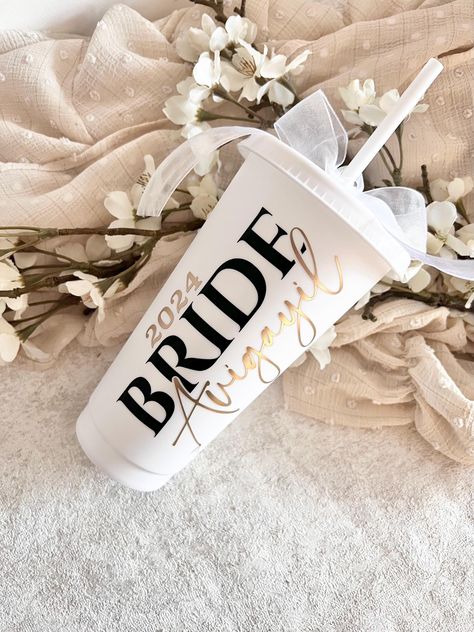 2025 Bride, Bride Cold Cup, Personalised Cold Cup with Straw, Gift for Bride, Hen Party Favours, Bride to Be, Cold Cup with Name, Bride, Wifey I'm so glad you've found my shop!  These cold cups are the perfect gift for any Bride to be!  My Bride Cold Cups come personalised with a name of your choice and available in two colours, both with an organza ribbon bow. Name Colour options - Gold  Silver  All names are added in a satin matte vinyl. Cold Cup Size - 24oz  My personalised Bride Cold Cups ar 2025 Bride, Cup With Name, Hen Party Favours, Cold Cups, Personalized Bride, All Names, Gift For Bride, Personalized Cups, Organza Ribbon