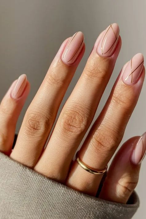 Hand with a gold ring displaying manicured nails with minimalist geometric nail art. Minimal Nails Almond Shape, Perfect Nails For Summer, Minimalist Vacation Nails, Nude Almond Nails Short, Nails Simplistic, Almond Nails Simple Design, Nail Minimal Design, Nude Design Nails, Short Nude Nails With Design