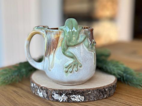 This unique mug will make your morning coffee or tea truly magical - a beautiful way to start your day! Approximate Size: Capacity - 10 fl.oz/ 300 ml In diameter - 2.9 inches/ 7.5 cm; Height - 3.5 inches/ 9 cm Mushrooms have a long history of being used for food, healing and spirituality thus they symbolise resilience, good relationships, nourishment, healing and flexibility. This original cup and decors is made from stoneware. Dishwasher and microwave safe. *Shipping Your order is SHIPPED FROM Food Healing, Mushroom Cup, 3d Ceramic, Small Coffee Cups, Ceramic Frogs, Sculptures Céramiques, Financial Abundance, Pretty Mugs, Fairy Gifts