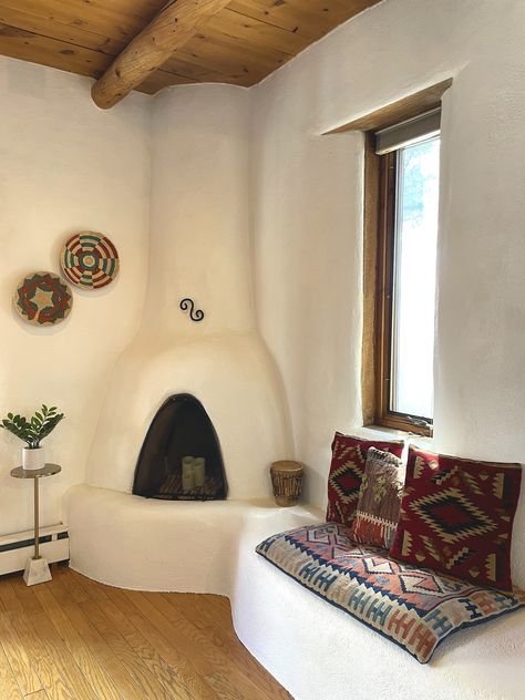 Chattadoe House - A dreamy vacation home in Taos, New Mexico. Kiva fireplace, kilim pillows, adobe, vigas ceilings Adobe Homes New Mexico, New Mexico Adobe Homes, New Mexico Home Interior, Adobe House Interior, Beehive Fireplace, New Mexico Style Home, New Mexico Decor, Adobe Fireplace, Southwest Living Room