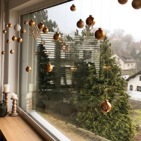 15 Ways to Decorate Your Home with Snowflakes and Baubles  #Christmasdecorations #Christmasornaments, Christmas Decoration Bauble Hanging Ideas, Ornaments In Window Hanging, Ornaments Hung From Ceiling, Hanging Baubles Decoration, Christmas Ornaments Hanging From Ceiling, Floating Ornaments From Ceiling, Hanging Baubles Ceiling, Hang Ornaments From Ceiling, Ornament Hanging Ideas