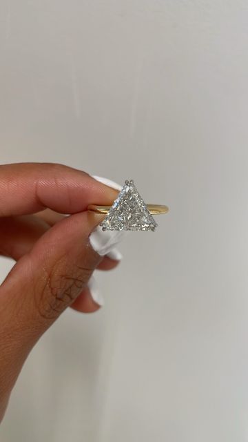 AARYAH on Instagram: "Mind, body spirit. Past, present, future. Of the many trinities that triangles represent, what will be the meaning you assign to it?  ~  Introducing TRINA. Our NEWEST ready to shop bridal style. It’s a beautiful 3.10crt cut corner triangle diamond engagement ring with a delicate setting to balance the boldness of the diamond shape. Handmade in nyc; a natural diamond with recycled, conflict free gold.  ~ . . . . . #AARYAH #AARYAHjewelry #AARYAHtribe #FeelThePower #WearTheStory #HandsThatMake #HandsThatCreate #WelcomeToAARYAH #FeelThePower #WearTheStory #wedding #proposal #weddingring #weddingdress #engagement #engaged #justengaged #engagementring #bridal #bridaljewelry #custom #customjewelry #bespoke #bespokejewelry #diamondring #diamonds #naturaldiamonds #diamondjewel Triangular Engagement Ring, Engagement Rings Triangle, Kite Shaped Engagement Ring Princess Cut, Kite Engagement Ring Princesses, Kite Cut Diamond Engagement Ring, Triangle Diamond, Just Engaged, Diamond Jewel, Past Present Future