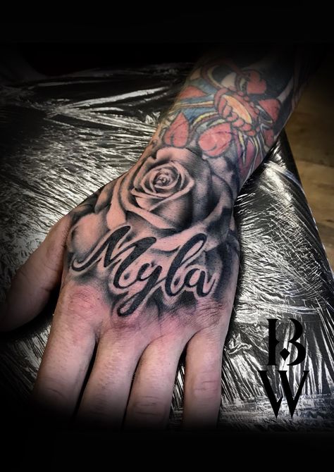 Rose hand tattoo. Men's tattoo. Child's name. By Beth wilde @ Wilde Ink, Wakefield. Cover Up Name Tattoos, Best Rose Tattoo, Hand Tattoos Pictures, Tato Nama, Name Tattoo On Hand, Rose Tattoo With Name, Herren Hand Tattoos, Tattoos About Growth, Small Wave Tattoo