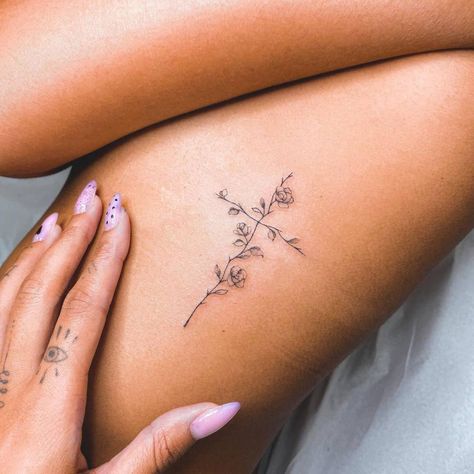 Fine line flower cross tattoo on the rib. Flower Cross Rib Tattoo, Beautiful Cross Tattoos, Cute Cross Tattoos For Women, Small Cross With Flowers Tattoo, Rib Cross Tattoos For Women, Flower With Cross Tattoo, Flower Cross Tattoos For Women, Spine Tattoos For Women Cross, Fineline Cross Tattoo