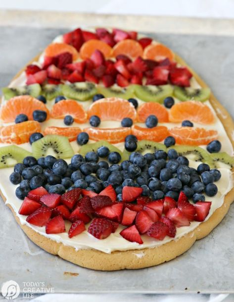 Sugar Cookie Easter Egg Fruit Pizza | Easy to make Easter treat. Cream Cheese frosting topped with your favorite fruits | Colorful Spring Dessert Ideas | TodaysCreativeLife.com Egg Fruit Pizza, Fruit Easter, Easter Egg Fruit Pizza, Watermelon Fruit Pizza, Sugar Cookie Fruit Pizza, Cookie Fruit Pizza, Homemade Sugar Cookie Dough, Sugar Cookie Pizza, Egg Fruit