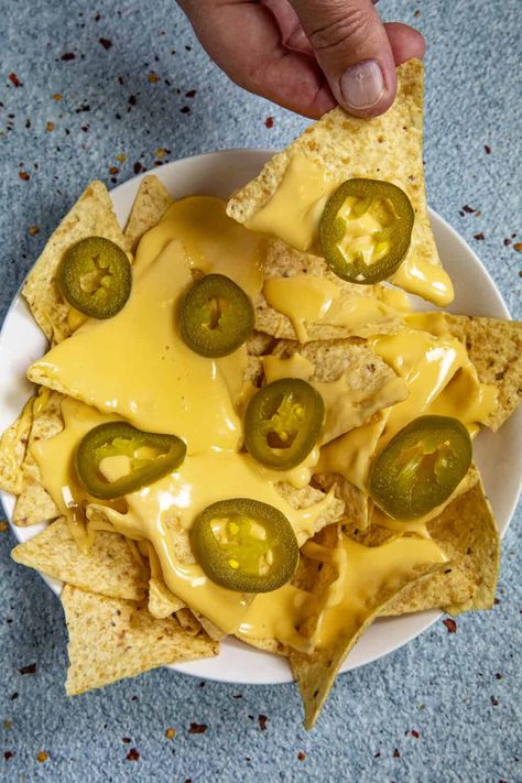 This spicy homemade nacho cheese sauce recipe is easy to make and tastes just like movie theater nachos with a trick I learned behind the concession stand.