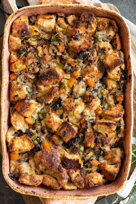 This simple vegetarian stuffing recipe should be a staple at every Thanksgiving and Christmas celebration! It’s savory, flavorful, and delicious with no need to bake bread ahead of time. https://www.savoringthegood.com/vegetable-stuffing-recipe/ Half Baked Harvest Thanksgiving Stuffing, Vegetarian Bread Stuffing, Herbed Stuffing Recipes, Worlds Best Stuffing, No Meat Stuffing, Vegetarian Dressing Stuffing, Vegetarian Thanksgiving Stuffing, Crispy Stuffing Recipes, Stuffing From Scratch Recipe