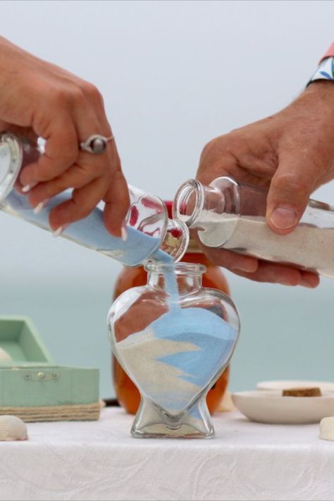 Unity Sand Jar Ceremony Wedding Ritual | Sarasota Florida Beach Wedding Service | Beach Wedding Planners | Florida Sun Weddings | Wedding Couple Pours Different Colored Sand into a Heart Shaped Jar | Wedding Memento | Beach Wedding Ideas Inspiration | Get Married on the Beach | Beach Wedding Ceremony Ideas | Blessign Shell Wedding Ritual Magenta Wedding Decorations, Sand Jar, Unity Ideas, Ariel Wedding, Magenta Wedding, Sand Ceremony Wedding, Wedding Ceremony Unity, Unity Sand Ceremony, Unity Sand