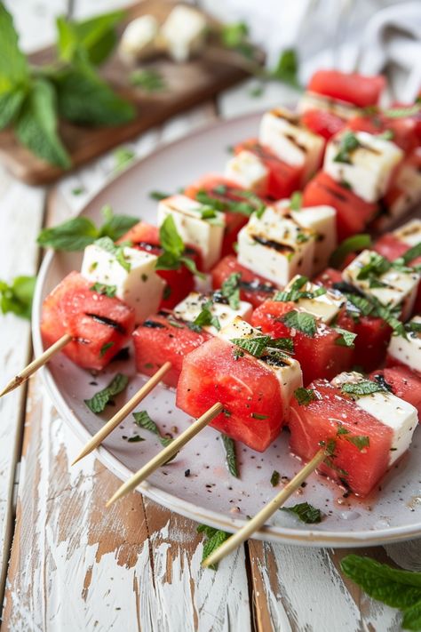 Watermelon and feta cheese skewers garnished with mint leaves on a white plate. Watermelon Feta Mint Salad, Cheesy Spinach Artichoke Dip, Salad Skewers, Roasted Cauliflower Steaks, Cheesy Spinach, Buffalo Cauliflower Bites, Easy To Make Appetizers, Mint Salad, Watermelon And Feta