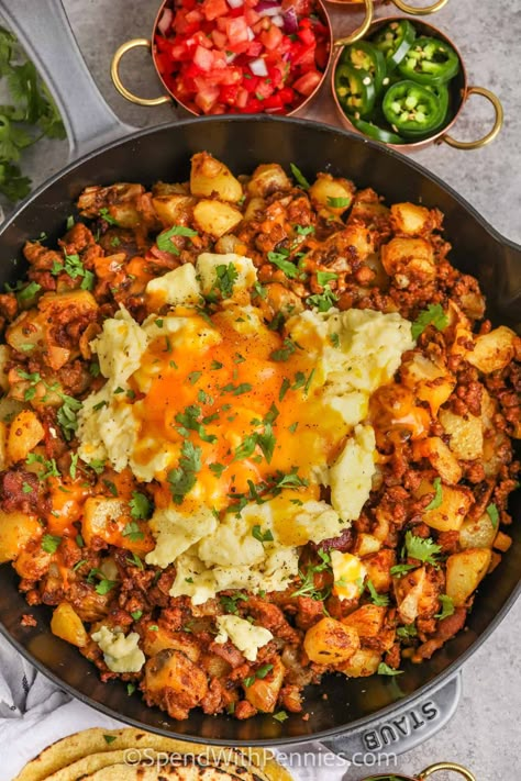 Start the day off right with this chorizo hash recipe. Spicy or sweet chorizo sausage is fried with bacon and then cooked with smooth and silky Yukon Gold Potatoes. Topped with eggs and cheese and then baked in the oven, this chorizo hash is so cheesy and filling. Make it a complete breakfast with a cup of coffee or tea!  #chorizohash #chorizobreakfast #beakfastchorizohash #spendwithpennies Papas And Chorizo, Chirozo Breakfast Recipes, Mexican Breakfast For A Crowd, Mexican Brunch Recipes, Savoury Breakfast Ideas Healthy, Chorizo Breakfast Recipes, Breakfast Scramble Skillet, Chorizo Recipes Breakfast, Chorizo Quiche