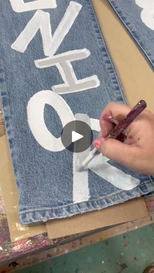 Painted jeans | Do you want to see me paint the back side too? | By Wayward WhimsyFacebook Homecoming Painted Jeans Ideas Diy, How To Paint Denim, Hand Painted Jeans Pants, Painted Pants Design, Painting On Jeans Aesthetic, Diy Painted Jeans, Wayward Whimsy, Jean Painting Ideas, Clothing Painting