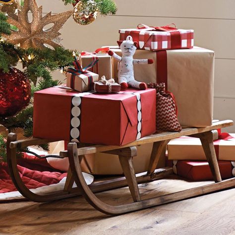 Wooden sleigh to hold Christmas presents Outdoor Christmas Presents, Christmas Sled Decoration, Christmas Sleigh Decorations, Christmas Party Games For Groups, Sled Decor, Christmas Booth, Christmas Coffee Table Decor, Wooden Sleigh, Lights For Christmas