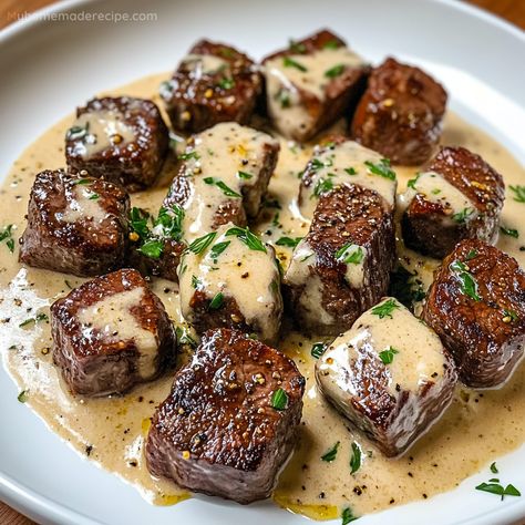 Garlic Butter Steak Bites paired with a luscious Parmesan cream sauce make a savory and satisfying dinner. Ready in just 25 minutes! Steak And Parmesan Sauce, Garlic Butter Steak Dinner, Steak Bites Cream Sauce, Steak Bites With Dipping Sauce, Garlic Bread Steak Bites Appetizer, Steak In Garlic Butter Sauce, Beef Garlic Bites, Buttered Beef Tips, Take Out Dinner Ideas