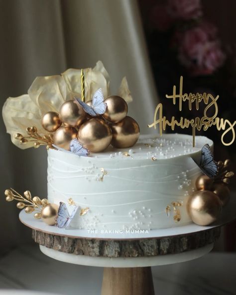 Celebrate your special moments with a touch of gold! This stunning anniversary cake, adorned with metallic spheres, delicate butterflies, and gold accents, is the perfect blend of elegance and sweetness. Whether it's for an anniversary, birthday, or any special occasion, let us craft a custom cake just for you! Ready to order? Message me on WhatsApp at 7044955912 and let's make your event unforgettable! #TheBakingMumma #AnniversaryCake #ElegantCakes #GoldAccents #CustomCakes #HomeBaker #Or... Elegant Anniversary Cakes, Attitude Video, Elegant Cakes, Graduation Cakes, Anniversary Cake, Custom Cake, Touch Of Gold, Custom Cakes, Special Moments