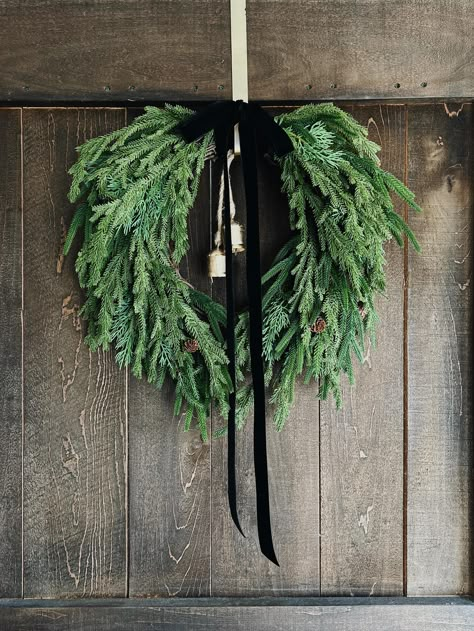 Boxwood Wreath With Ribbon Front Doors, Wreath With Black Ribbon, Xmas Entryway Decor, Green Gold Black Christmas Decor, Add Bow To Wreath, Norfolk Pine Wreath Ideas, Wreath Velvet Ribbon, Norfolk Pine Wreath, Velvet Ribbon Wreath