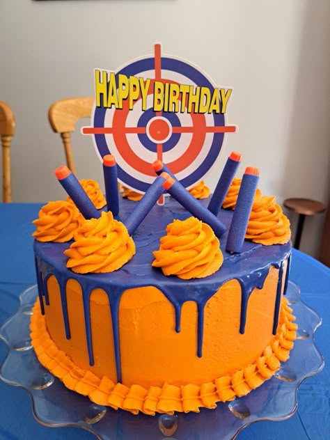 Nerf birthday cake with candy-melt ganache drip Cool Cakes For Men, 8th Birthday Boy Party Theme, Nerf Cake Ideas, Nerf Birthday Cake, 9 Birthday Cake, Nerf Birthday Party Ideas, Nerf Cake, Ganache Drip, Candy Melt