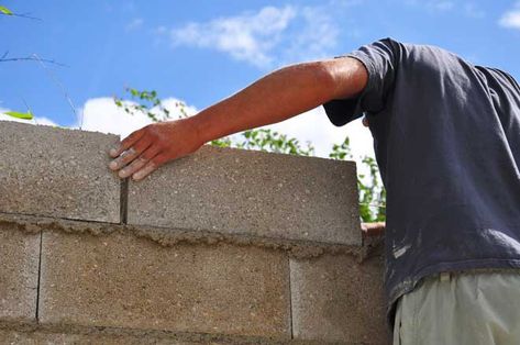 © coco / Adobe Stock Cinder block walls are practical and budget friendly, but they're not always the most attractive option nor are they particularly Cinder Block Exterior House, Concrete Fence Design, Block Walls Ideas Outdoor, Cinder Block Walls Interior Makeover, Concrete Wall Ideas, Cinder Block Foundation, Cinderblock Wall, Painting Concrete Walls, Homestead Plans