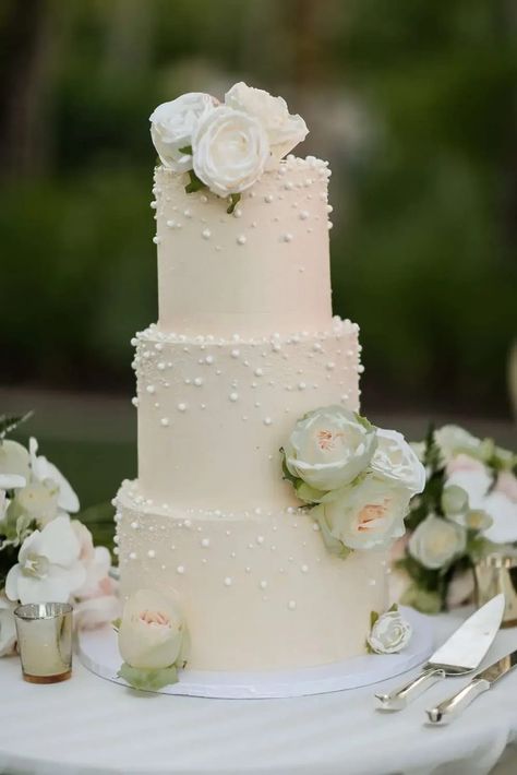 This pearl wedding cake with pearl inspired wedding details was the perfect choice for this destination wedding. Save this pearl wedding cake for inspiration for your unique wedding cake! Blue Pearl Wedding Cake, Destination Wedding Cake Ideas, Two Tier Pearl Wedding Cake, 4 Tier Pearl Wedding Cake, White Wedding Cake With Pearls And Flowers, 3 Tier Wedding Cake With Pearls, Pearls On Wedding Cake, Pearl And Flower Wedding Cake, Wedding Pearl Cake