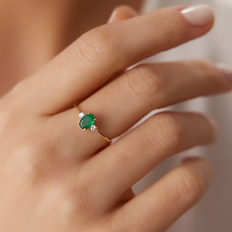 This stunning ring features a round emerald surrounded by diamonds in a halo setting. The ring is made of 14k white gold. #emeraldring #diamondring . #Everyday_Emerald_Ring #Emerald_Ring_Ideas #Emerald_White_Gold_Ring #Small_Emerald_Ring