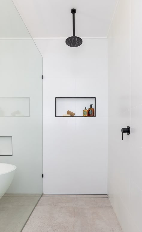 One of the benefits of having a large bathroom is being able to have a large shower. Easy access to the mixer and a place to store your shampoo is a must. I love the crispness of the all white walls and the touches of black in this recently completed bathroom. 🖤 Read how we transformed this bathroom and see all the pics on our Blog REVEAL | A Calm & Serene Bathroom. 🌿 . . Design: @my_bellavie 📷: @elouise_photographer Large White Tile Bathroom Walls, Big White Tiles Bathroom, White Matte Shower Tiles, Big White Tile Shower, Large White Wall Tiles Bathroom, Ensuite White Tiles, Large White Tile Bathroom, Large White Bathroom Tiles, Large White Rectangle Tile Bathroom