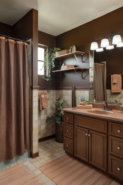 A cozy brown bathroom with tan tiles and wooden accents, creating a warm and inviting space. Brown Granite Bathroom Decor, Tan Brown Bathroom Ideas, Brown Sink Bathroom, Bathroom Decor Ideas Brown, Bathroom Remodel Brown Tones, Brown Cabinet Bathroom, Brown Vanity Bathroom Ideas, Brown Bathroom Cabinets, Brown Tile Bathroom Ideas Color Palettes