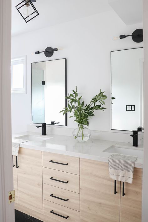 A modern high contrast principal ensuite with wood-grain double vanity, matte black hardware, quartz countertops and modern light fixtures Farmhouse Bathroom Design, White Bathroom Designs, Matte Black Bathroom, Bathroom Light Fixtures, Bathroom Renos, Bathroom Remodel Master, House Bathroom, Black Bathroom, White Bathroom