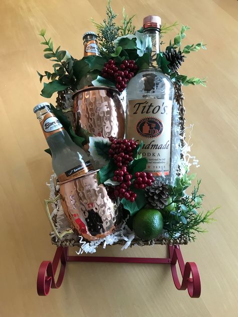 Moscow Mules for Christmas! Tito’s vodka, ginger beer, and lime. Add a splash of cranberry and a few frozen cranberries for a holiday twist! Alcohol Christmas Basket, Christmas Gift Baskets With Alcohol, Liquor Basket Ideas Christmas, Tito’s Vodka Gift Basket, Christmas Booze Basket, Tito’s Gift Basket, Vodka Christmas Gifts, Booze Basket Ideas Christmas, Neighbor Christmas Gifts Alcohol