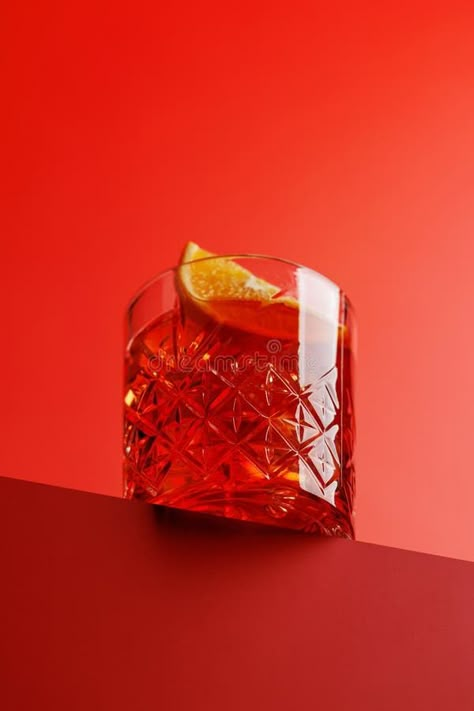 Cocktail delight: Classic negroni against a red background stock photos Negroni Photography, Cocktail Advertising, Negroni Aesthetic, Cocktail Photography Creative, Negroni Drink, Cocktail Shoot, Cocktail Packaging, Classic Negroni, Light Food Photography