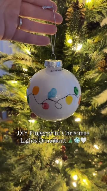 Jules | DIY baby + toddler photos • Motherhood on Instagram: "DIY Fingerprint Christmas Lights Ornament 🎄❄️🤍   Want to do this with your littles?  Make sure you’re following @diyphotoshootmom and comment DIY ORNAMENT and I’ll send you the step-by-step directions and the supplies I used to DIY your own special fingerprint Christmas lights ornament to cherish and hang on your Christmas tree    Make sure you’re following to receive the link!   Christmas crafts / Christmas gifts / diy ornament / keepsakes / diy mom / baby keepsakes / Christmas baby / toddler crafts / Christmas with kids / first Christmas / baby’s first Christmas / first time mom / pregnant / christmas ornament / special ornament / diy ornament ideas" Christmas Ornament Crafts Clear Ball, Fingerprint Christmas Ornaments Kids, Toddler Christmas Handprint Ornament, Baby Hand Christmas Ornament, Christmas Craft Ornaments For Toddlers, Fingerprint Lights Ornament, Baby Footprint Christmas Tree, Finger Print Christmas Tree Ornament, Baby Fingerprint Ornament