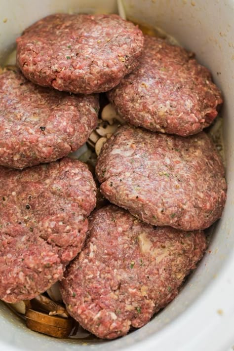 A favorite family meal this easy Salisbury steak recipe is made in the slow cooker making it an easy weeknight dinner Slower Cooker Salisbury Steak, Crockpot Burger Recipes Beef, Hamburger Meat In Crockpot Recipes, Burgers In Sauce Crockpot, Crockpot Hamburger Patties, Lipton Onion Soup Mix Salisbury Steak, Cube Steak Salisbury Steak, Slow Cooker Hamburger Steaks, Frozen Hamburger Patties Recipes Crock Pot