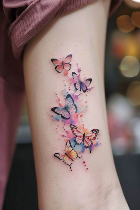 Explore the deep symbolism and elegance behind butterfly tattoos. As timeless representations of transformation, beauty, and freedom, these delicate creatures capture the imagination with their intricate wings and graceful flight. Whether you prefer minimalist outlines or vibrant, realistic designs, there are endless possibilities to create stunning body art that reflects your unique style and personality through the enduring symbol of the butterfly. Watercolour Tattoo Ideas, Butterfly And Dragonfly Tattoo, Colored Butterfly Tattoo, Beautiful Butterfly Tattoos, Watercolor Tattoo Design, Watercolor Butterfly Tattoo, Font Tato, Coretec Flooring, Colour Tattoos