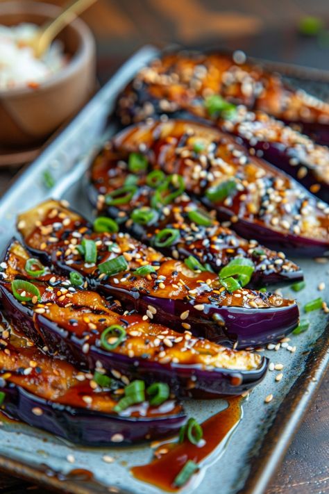 Roasted eggplant topped with sesame seeds, chopped green onions, and a savory sauce on a ceramic plate. Miso Glazed Aubergine, Japanese Side Salad, Purple Salad Recipes, Miso Glazed Eggplant Recipe, Miso Eggplant Japanese, Grilled Japanese Eggplant, Aubergine Side Dish, Beat Leaves Recipes, Eggplant Miso Recipe