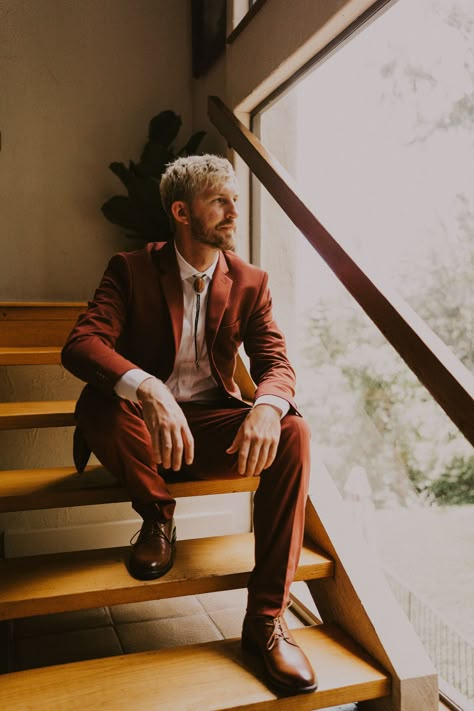 Casual Groom Suits For Wedding, Rust Orange Groom Suit, Guy Elopement Outfit, Burnt Orange Suit Wedding, Retro Wedding Suit Men, Rust Tuxedo Wedding, Bolo Tie Men Wedding, Funky Groom Attire, Retro Groom Attire