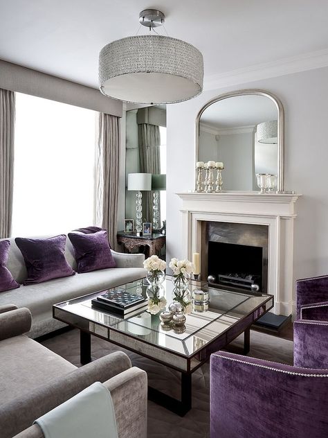 Shades of metallic silver glint in this amethyst and silver living room. The mirrored coffee table and French over-mantle mirror add an extra silver element. Silver Living Room, Purple Furniture, Purple Living Room, Purple Decor, Trendy Living Rooms, Elegant Living Room, Elegant Living, Beautiful Living Rooms, Living Room Grey