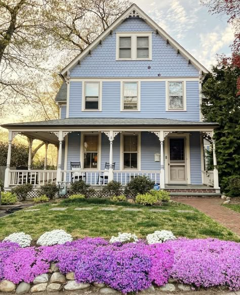 White House Blue Shutters Wrap Around Porch, Suburban House Wrap Around Porch, Blue House With Wrap Around Porch, Pastel Blue House Exterior, Blue House Wrap Around Porch, Wrap Around Porch Cottage, Light Blue Cottage Exterior, Colorful Farmhouse Exterior, Blue House With Porch