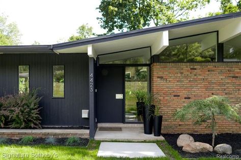 Mid Century Exterior Brick, Midcentury Ranch Exterior Before And After, Mid Century Modern House Exterior Brick, Midcentury Home Exterior Paint Colors, Black Mid Century House Exterior, Mid Century Brick House Exterior, Red Brick Mid Century Modern Exterior, Black Mid Century House, Mid Century Modern Entrance