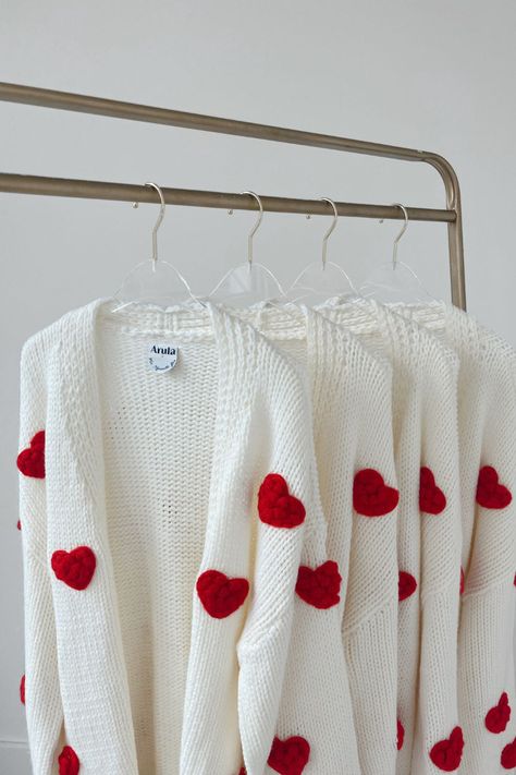 You need this heart cardigan! Feel all the love in this cozy cardigan! The perfect pairing piece, this cardigan features a dreamy soft texture that's adorned with heart embroidery. Layer with your favorite tiered dress and add tall boots for a feminine, oh-so romantic look! #sweater #valentinesday #ootd Layering Essentials, Clothing Crochet, Diy Designs, Heart Cardigan, Crewneck Sweaters, Heart Embroidery, Plus Size Cardigans, Heart Sweater, Crochet Square Patterns