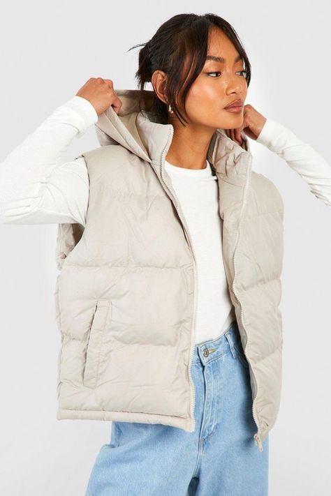 Womens Hooded Vest - Beige - 10 - Add a different type of layer to your look with this vest, a sporty and stylish piece. This sleeveless jacket closely resembles a waistcoat and is perfect for throwing over long sleeve tops, sweaters, and lightweight coats. This body warmer can add that much-needed extra insulation to your outfit during colder months without making you feel too bulky. Style this women's vest with a sports outfit, work attire, or everyday look.Style: GiletFabric: PolyesterNecklin Womens Hooded Vest, Winter Outfit Ideas For Women, Waistcoat Designs, Hooded Gilet, Faux Fur Gilet, Women's Vests, Winter Fashion Inspiration, Winter Travel Outfit, Sports Outfit