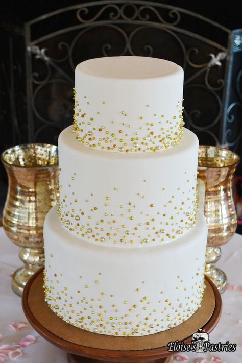 This simple wedding cake becomes the star of the show with the addition of subtle gold beads on each tier. Cakes with understated but elegant decor are perfect for weddings in any season. #EloisesPastries #bakery #weddingcake #weddings #cake #gold #weddingseason Gold Anniversary Cake, Golden Wedding Cake, Golden Wedding Anniversary Cake, 50th Wedding Anniversary Decorations, 50th Wedding Anniversary Cakes, 50th Anniversary Cakes, Spring Wedding Cake, 50th Wedding Anniversary Party, Wedding Anniversary Cakes